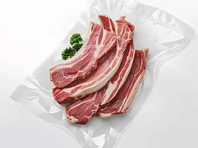Packaged processed meat for an integrated packaging line